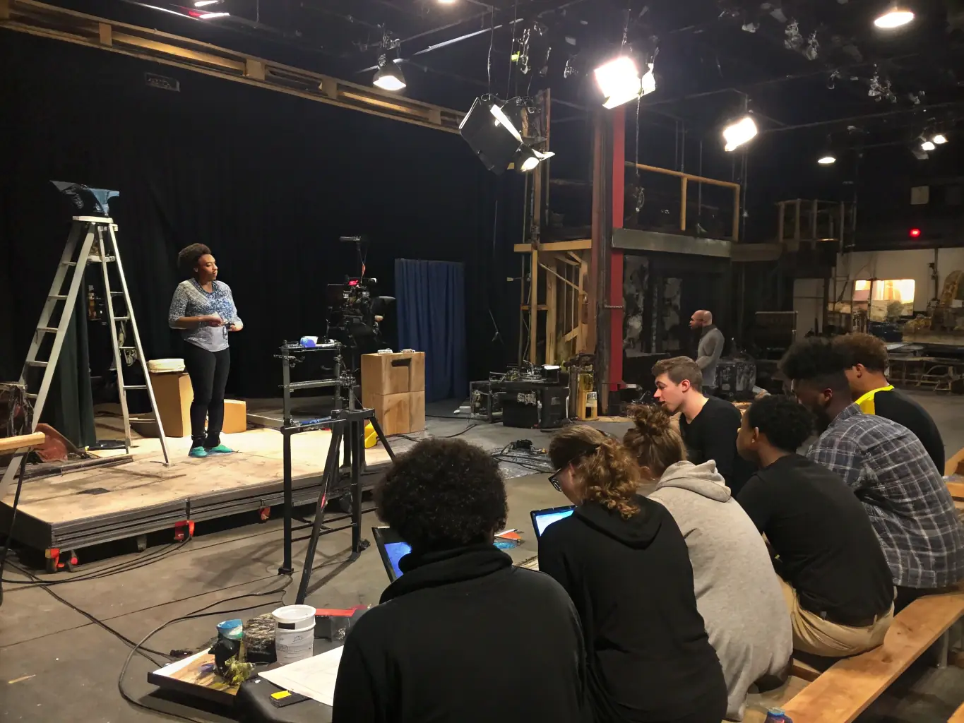 A workshop in progress where technicians are learning about stage lighting and sound, reflecting ARTS AIDE's commitment to technical training.